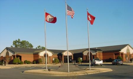 Flags Flying High in Front of a Building